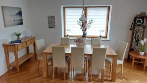 uma sala de jantar com uma mesa de madeira e cadeiras em Chiemsee-Ferienhaus Schlegel em Breitbrunn am Chiemsee