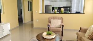 a living room with a chair and a table at Zeyden Place Apt in Praia