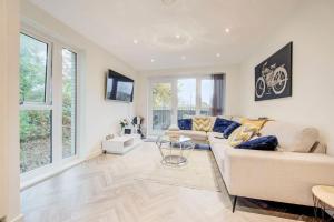 a living room with a couch and a table at Beautifully furnished 3-bed apartment near Wembley Stadium in Wealdstone