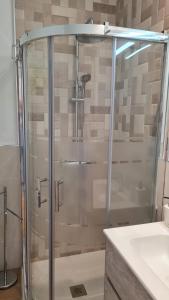 a shower with a glass door in a bathroom at Apartamentos Bahia Mar casa B in Las Negras +14 photos