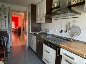 a kitchen with a sink and a counter top at Apartamento Guadalquivir - Parking Privado Opt in Seville