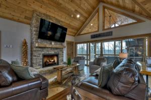 a living room with leather furniture and a fireplace at A Great Escape in Ellijay