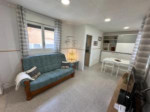 a living room with a couch and a table at Apartamento con terraza Delta Slow in Deltebre