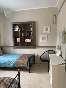 a bedroom with a bed and a book shelf at Εξοχικό elia lakonias in Elia Laconias