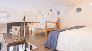a bedroom with a bed and a chair and a table at Apartamentos Zocosol by Toledo AP in Toledo
