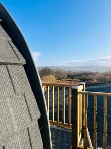 a balcony with a view of the water at Hidden Hut - Aros View - Tobermory in Tobermory