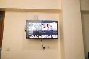 a flat screen tv hanging on a wall at The Modern loft in Nairobi