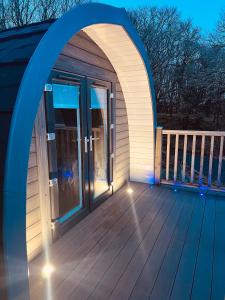 an arched door on a deck at night at Hidden Hut - Aros View - Tobermory in Tobermory