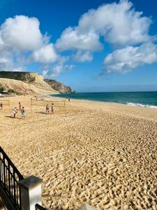 a group of people playing soccer on a sandy beach at Casa Da Praia in Luz +9 photos