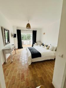 a bedroom with a bed and a desk and a window at Casa Da Praia in Luz