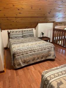 a bedroom with two beds and a wooden ceiling at Deluxe Cabin #10 with Jacuzzi on Patoka Lake in Southern Indiana in Seymour