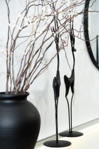 two black vases sitting on a table with a plant at Zoe's House in Polykárpion