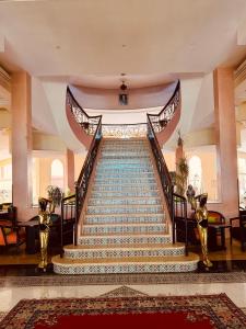 a staircase in a building with a stair case at Hotel Idou Tiznit in Tiznit