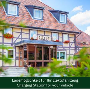 a hotel with a sign on the front of it at Hotel & Restaurant Ernst in Giesen