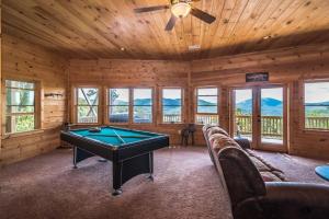 a room with a pool table in a cabin at Majestic mountaintop cabin, hot tub, fireplaces in Craytonia