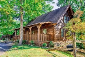 a log cabin with a fence in front of it at Heavenly Peace in Pigeon Forge