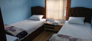 Postel nebo postele na pokoji v ubytování KARYA OTEL