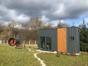 a small house in the middle of a field at TinyHouse & Garden in Geceľ