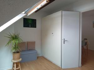 a room with a white wardrobe and a plant at Appartement vallée de Campan in Campan