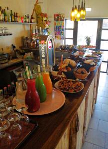 a counter with many plates of food on it at CASA DA HORTA in Aljezur +18 photos