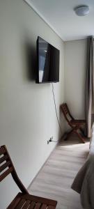 a living room with a tv on a white wall at Alojamiento boutique , Valparaíso 402 in Viña del Mar