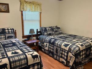 a bedroom with two beds and a window at Two Bedroom Cozy Cabin #14 on Patoka Lake in Southern Indiana in Paoli