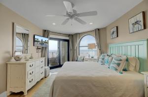 a bedroom with a bed and a ceiling fan at 211 Seascape by AvantStay Oceanfront View Pool in Isle of Palms