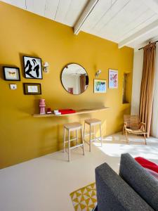 a living room with yellow walls and a mirror at SPOT Jelsum in Jelsum
