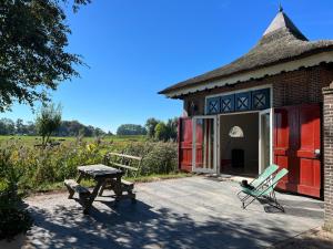 a building with a bench and a table in front of it at SPOT Jelsum in Jelsum