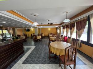 a dining room with tables and chairs and a table at Hotel Santander in Termas de Río Hondo