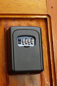 a remote control on a wooden door with a handle at The Modern loft in Nairobi