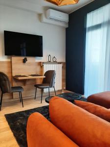 a living room with a tv and a couch and chairs at Belgrade Waterfront Lux Studio Apartment in Belgrade +18 photos