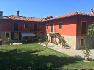 a large house with a lawn in front of it at Cascina Filipot in Cerretto Langhe