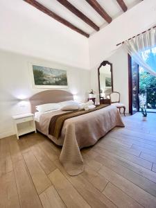 a bedroom with a large bed and a large window at Giulio Cesare 14, Residence in Palermo