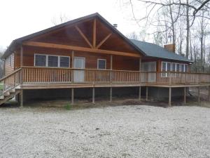 a large wooden house with a large deck at Solarium Deluxe Cabin #19 on Patoka Lake in Southern Indiana in Seymour
