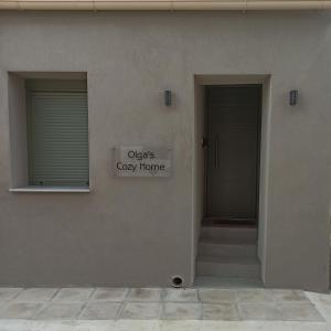 a building with two doors and a sign that reads objects grey home at Olgas cozy home in Chania