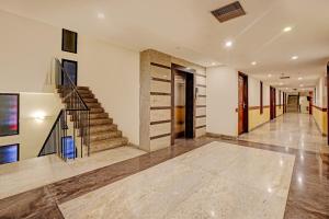 a hallway of a home with a staircase and a stair case at OYO Palette - Hotel Victoria in Chennai