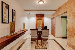 a home office with a desk with a laptop on it at OYO Palette - Hotel Victoria in Chennai