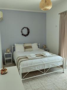 a white bedroom with a bed in a room at Calypso Two Bedroom Apartment in Kandia