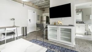 a living room with a flat screen tv on the wall at Landing Modern Apartment with Amazing Amenities (ID1803X66) in Mobile