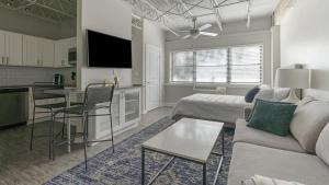 a living room with a couch and a table and a kitchen at Landing Modern Apartment with Amazing Amenities (ID1803X66) in Mobile