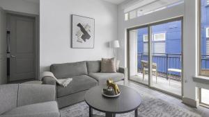 a living room with a couch and a table at Landing Modern Apartment with Amazing Amenities ID1803X06 in Houston