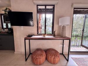 a table with two ottomans in a living room at Loft Amalfi en Val'Quirico in Santeagueda