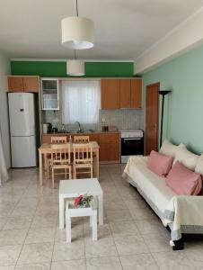 a living room and kitchen with a couch and a table at Calypso Two Bedroom Apartment in Kandia