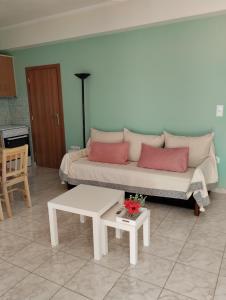 a living room with a couch and a table at Calypso Two Bedroom Apartment in Kandia +9 photos