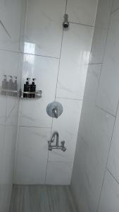 a bathroom with a shower with a light on the wall at Your Home in Rotorua 3 Frank Street in Rotorua