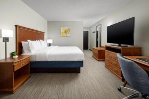 a hotel room with a bed and a flat screen tv at Hampton Inn Memphis-Walnut Grove/Baptist East in Memphis