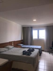 En eller flere senge i et værelse på Flat Ponta Negra vista para o mar