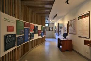 a hallway with a desk and posters on the wall at Arenal Observatory Lodge & Trails in Fortuna +178 photos