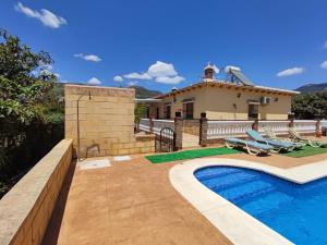 a villa with a swimming pool and a house at Los Olivos in Málaga +24 photos